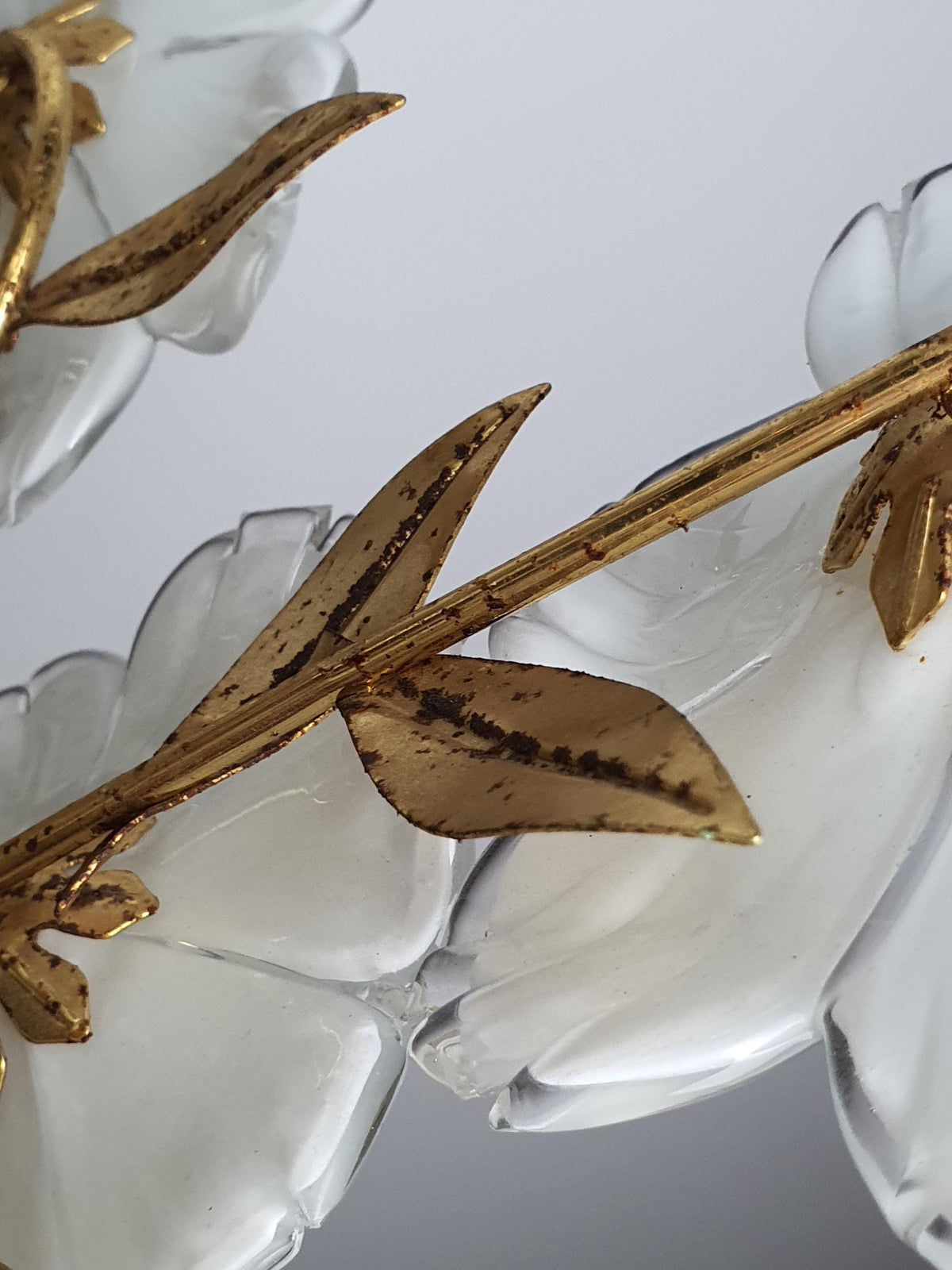 Close-up of white semi-transparent ribbed Murano glass flower petals on vintage 1980s floral chandelier