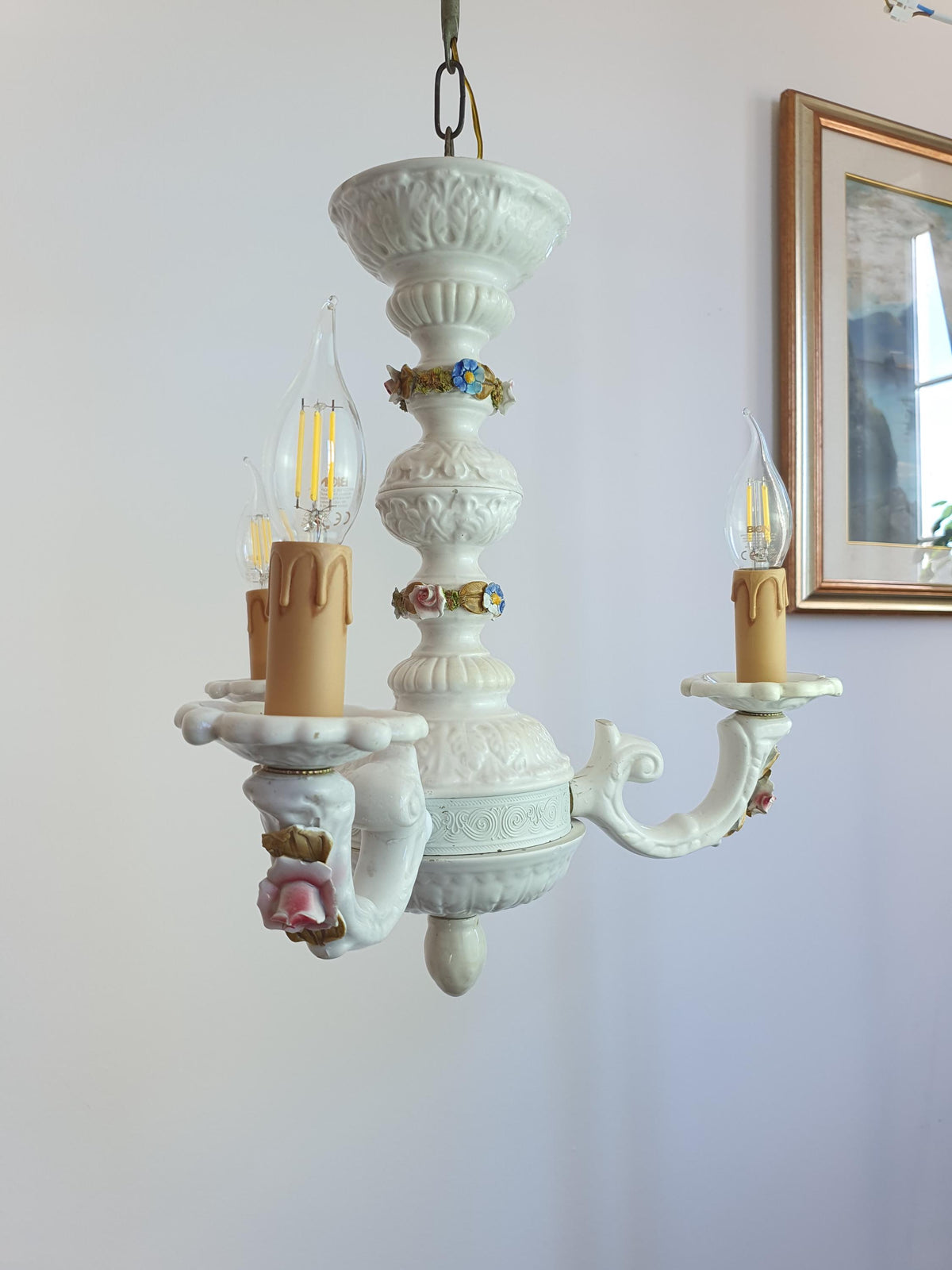 Small losses in the decorative ceramic and porcelain details of a vintage chandelier
