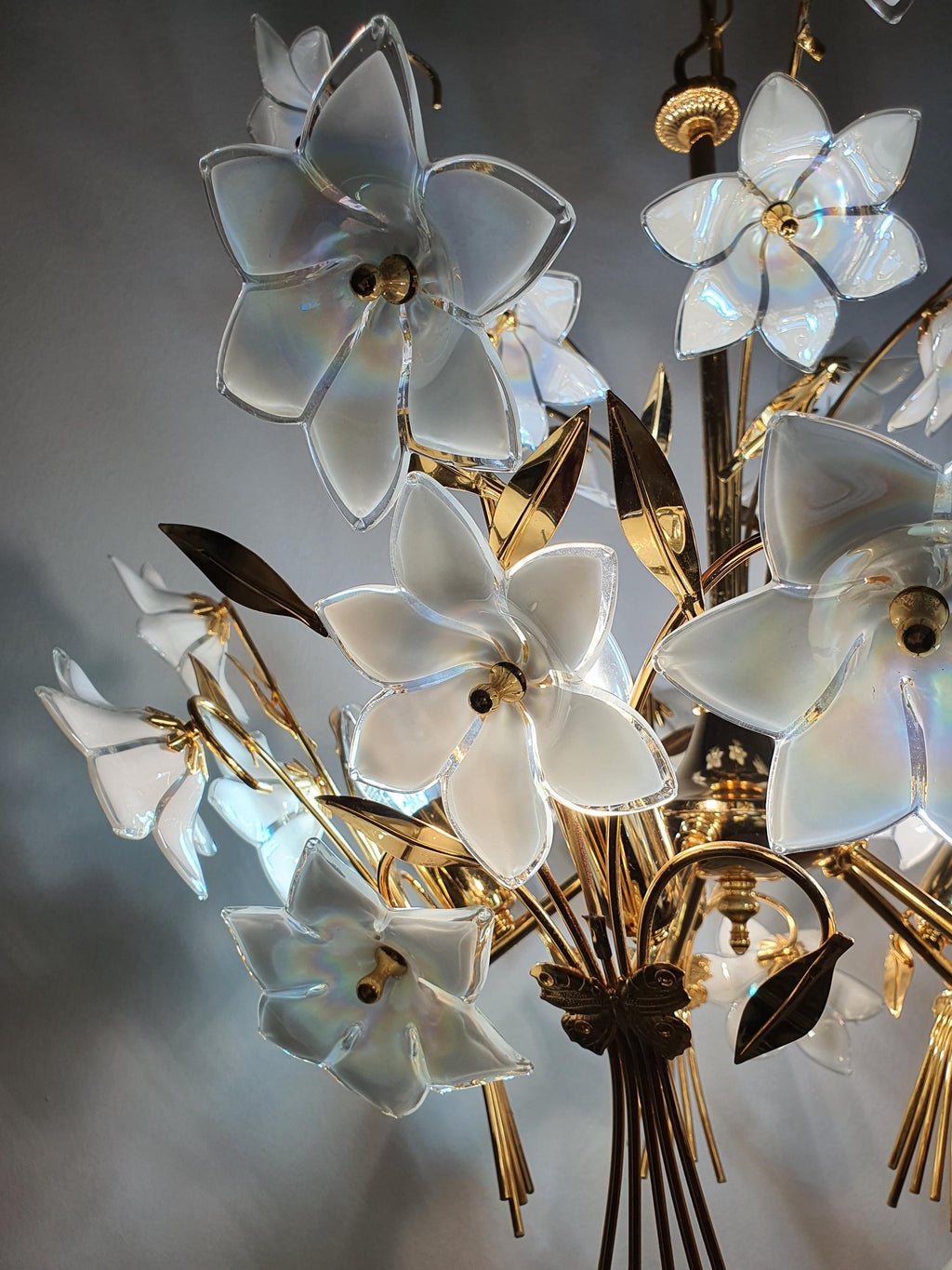 Detail of gold-toned metal structure and iridescent white Murano glass flowers, 5-arm bouquet chandelier