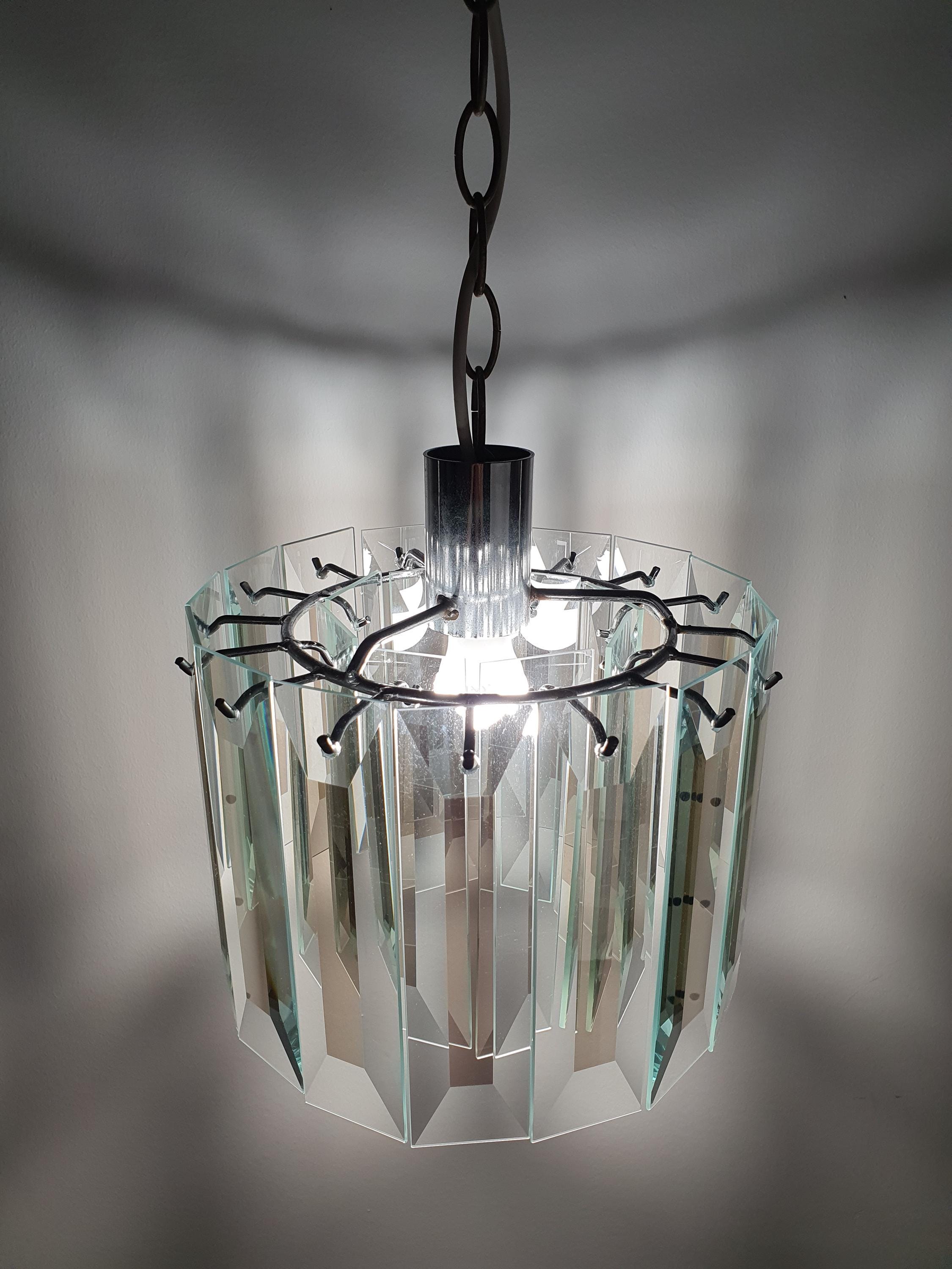 Vintage Art Deco chandelier in bathroom, crystal glass petal refraction, aged chrome, intimate French Deco glamour