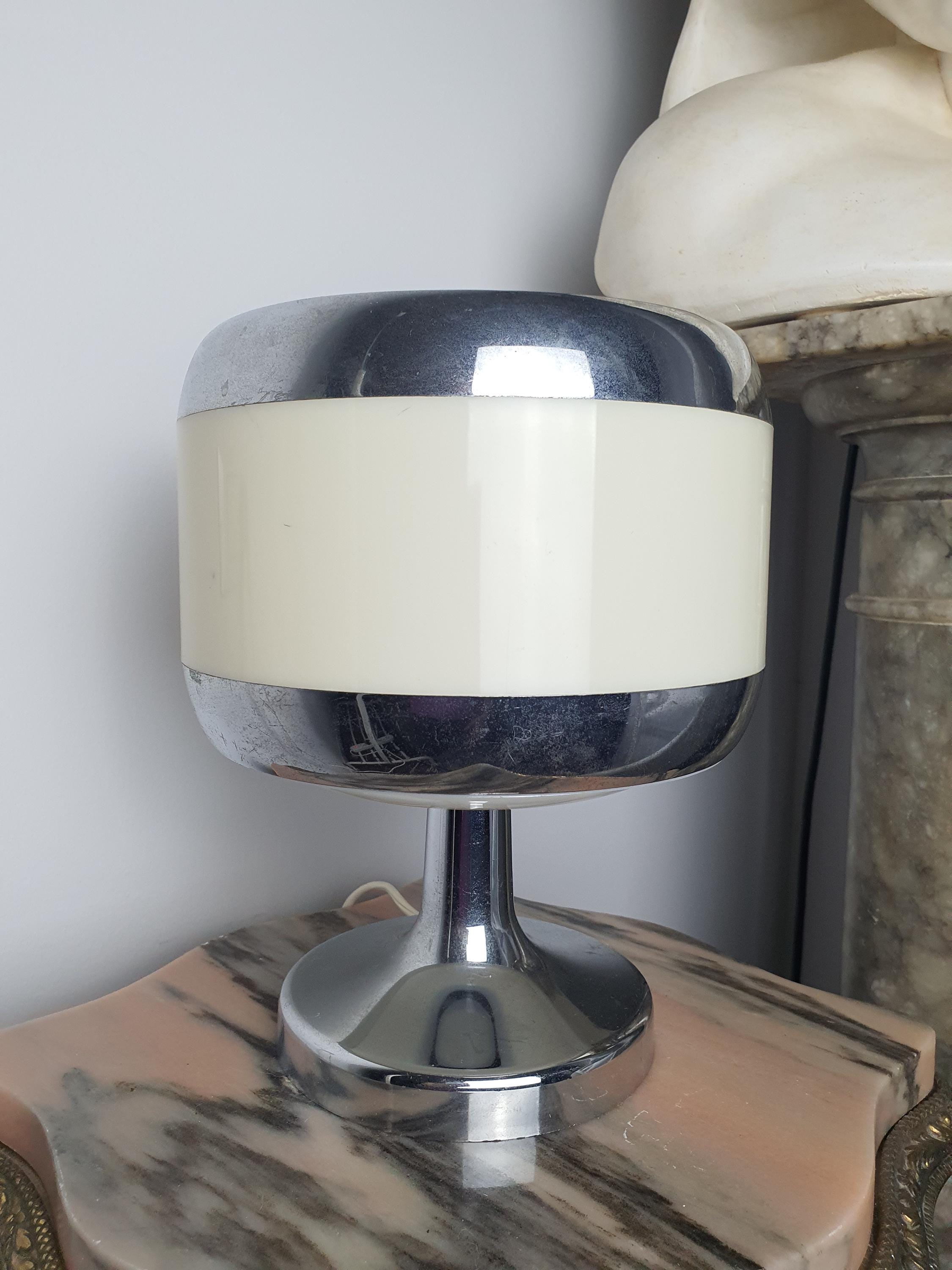 Close-up of chrome-plated details on vintage 1970s Italian Space Age table lamp, reflective chrome on beige ABS body