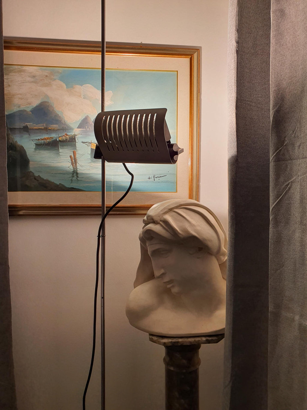 Joe Colombo Model 626 floor lamp beside lounge chair, Mid-Century Modern interior, directed task lighting