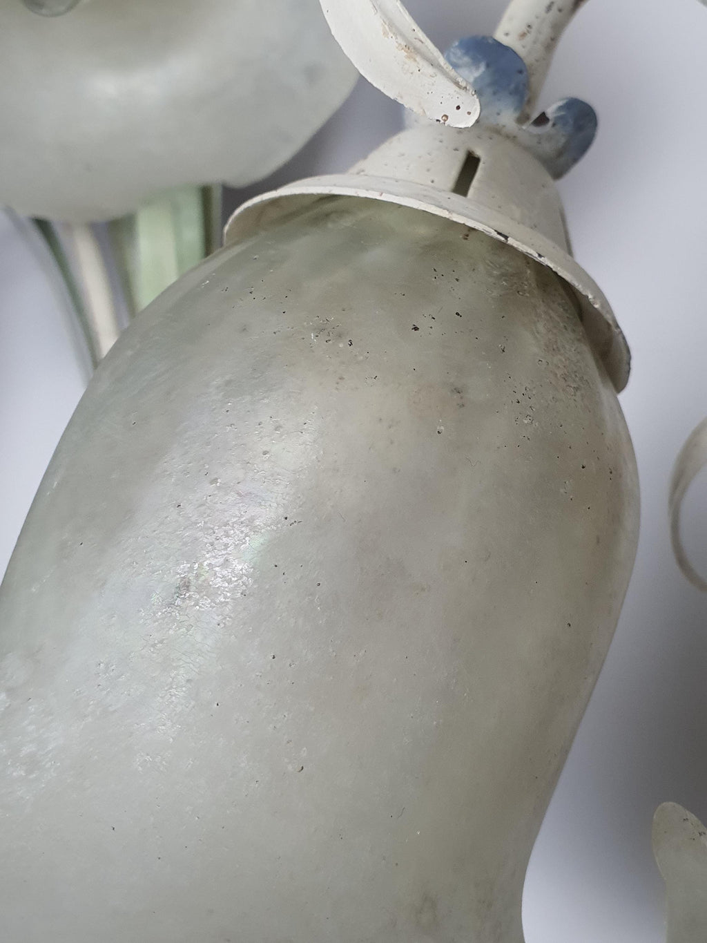Vintage Italian toleware sconce — blooming iris flowers and beige green blue tones, close-up
