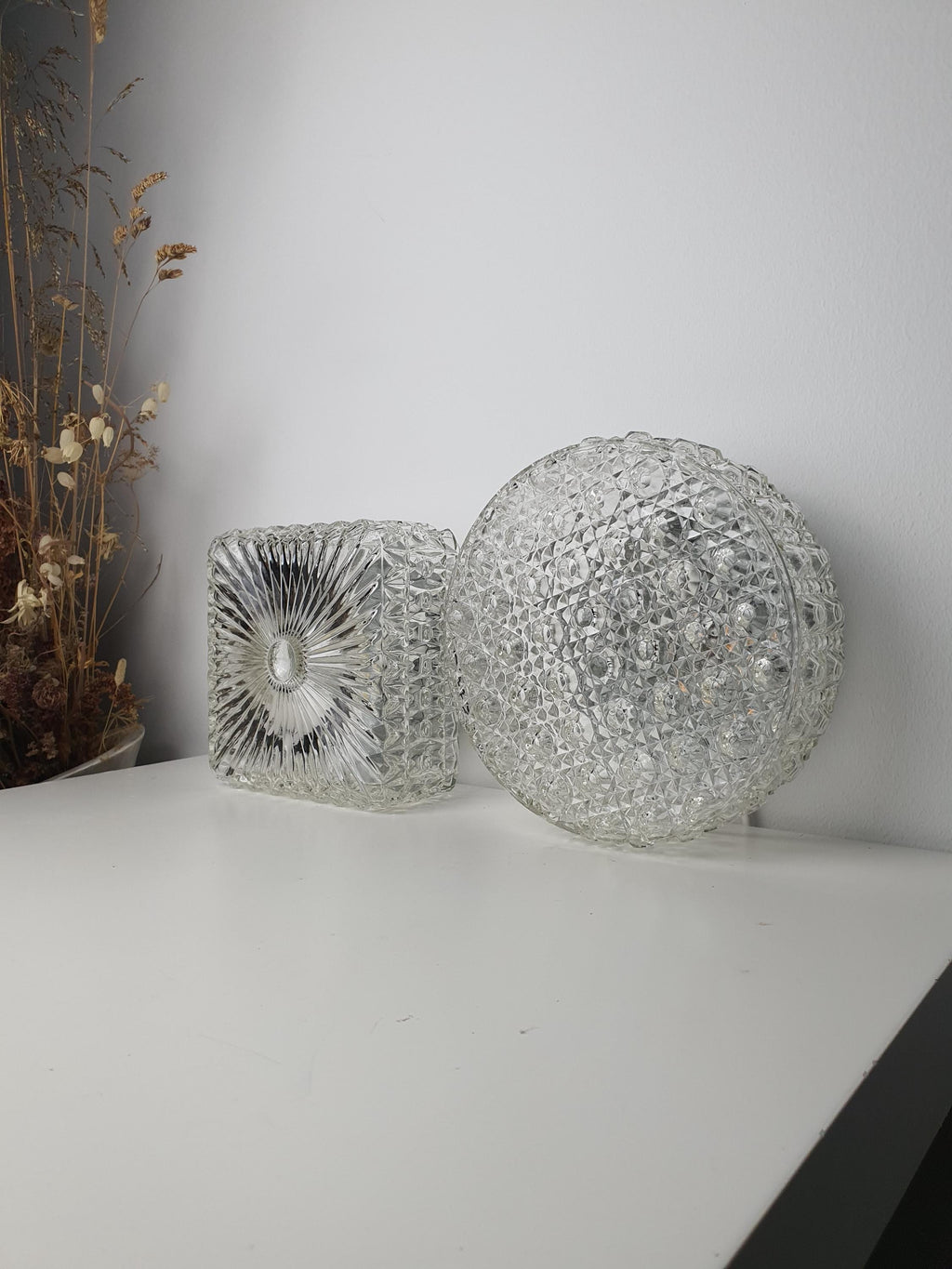 Side profile of a compact vintage textured-glass wall sconce
