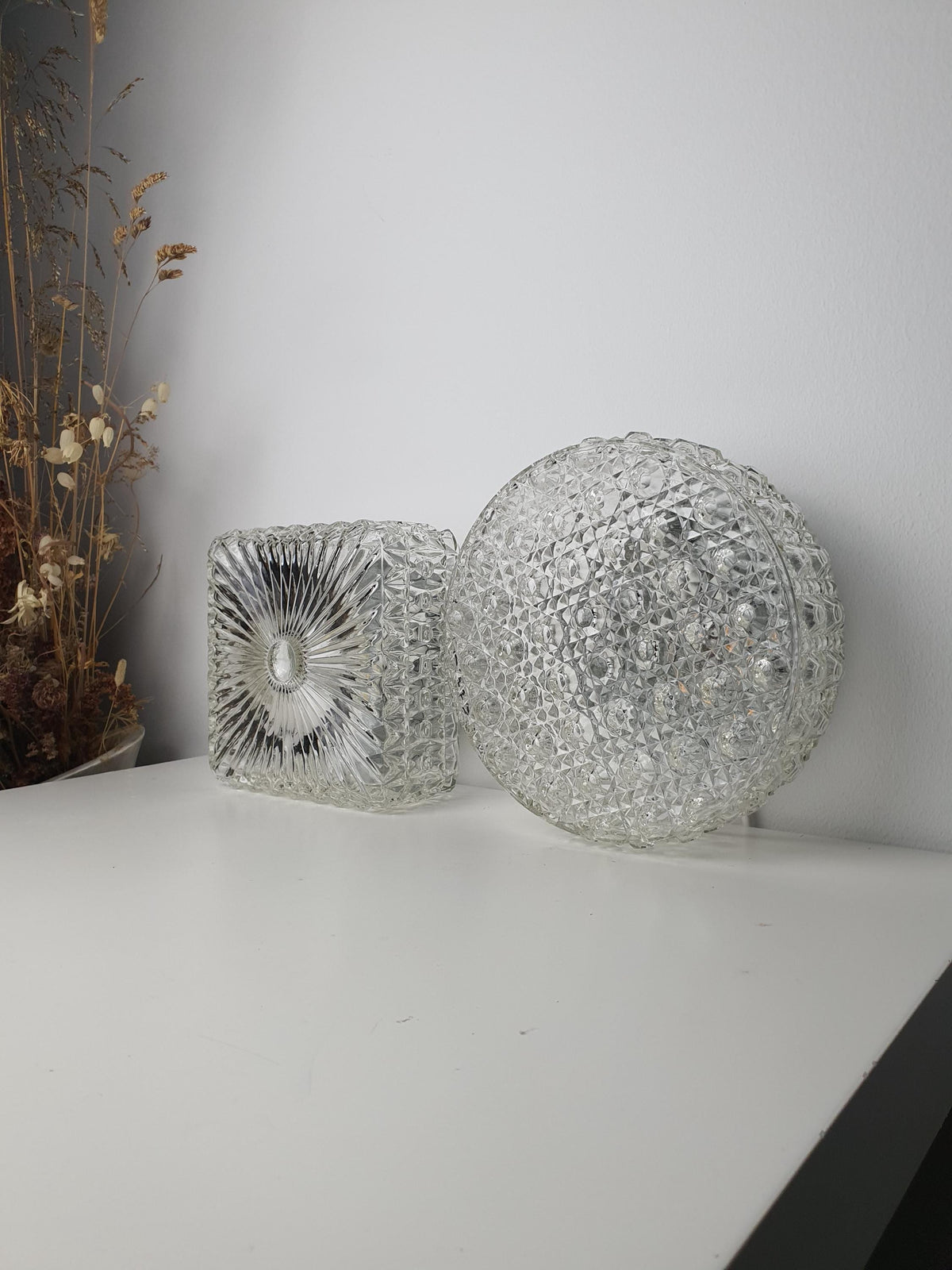 Side profile of a compact vintage textured-glass wall sconce
