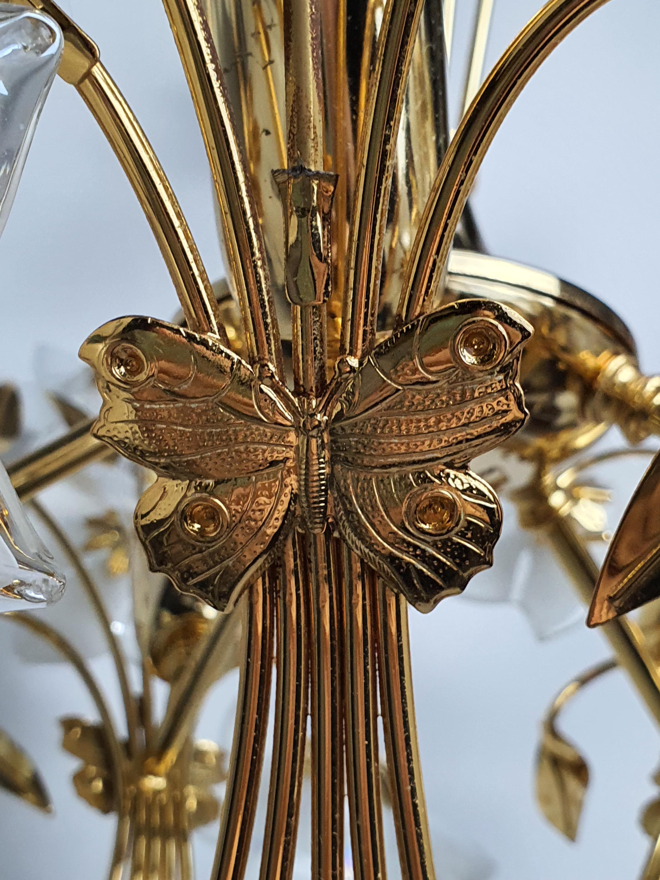 Murano glass bouquet chandelier side profile, layered iridescent white flowers, gold-toned arms and structure