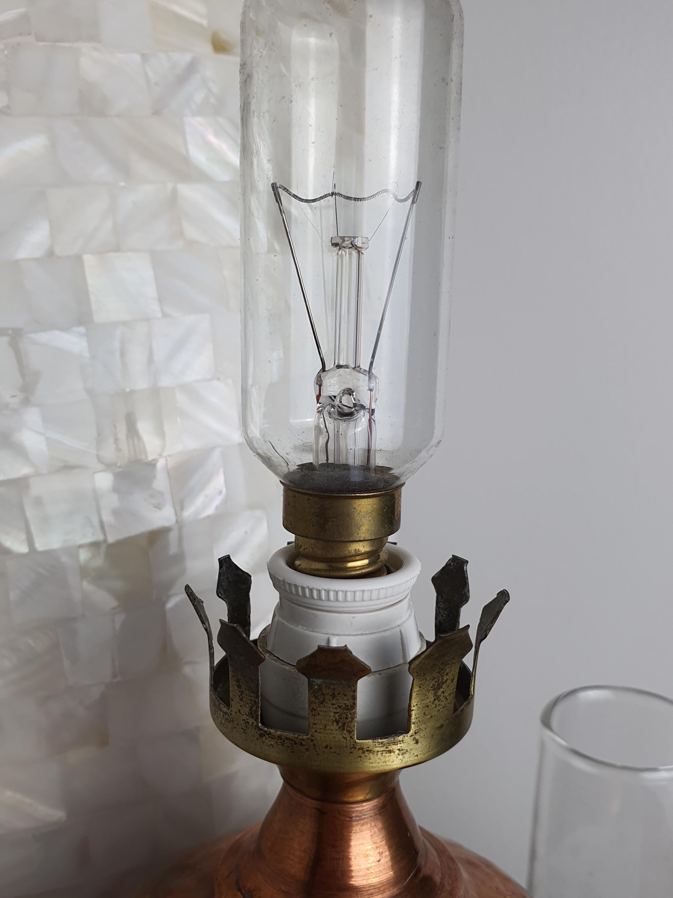 Vintage 1950s Italian copper oil lamp in reading nook, slender oil lamp silhouette, frosted spotted glass, cosy accent light