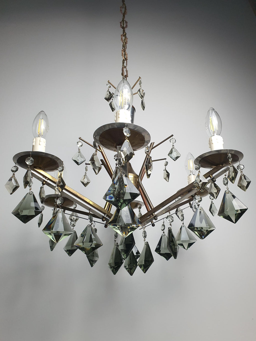 Art Deco 6-arm chandelier front view, smoky grey crystal drops cascading from brass chrome branching frame