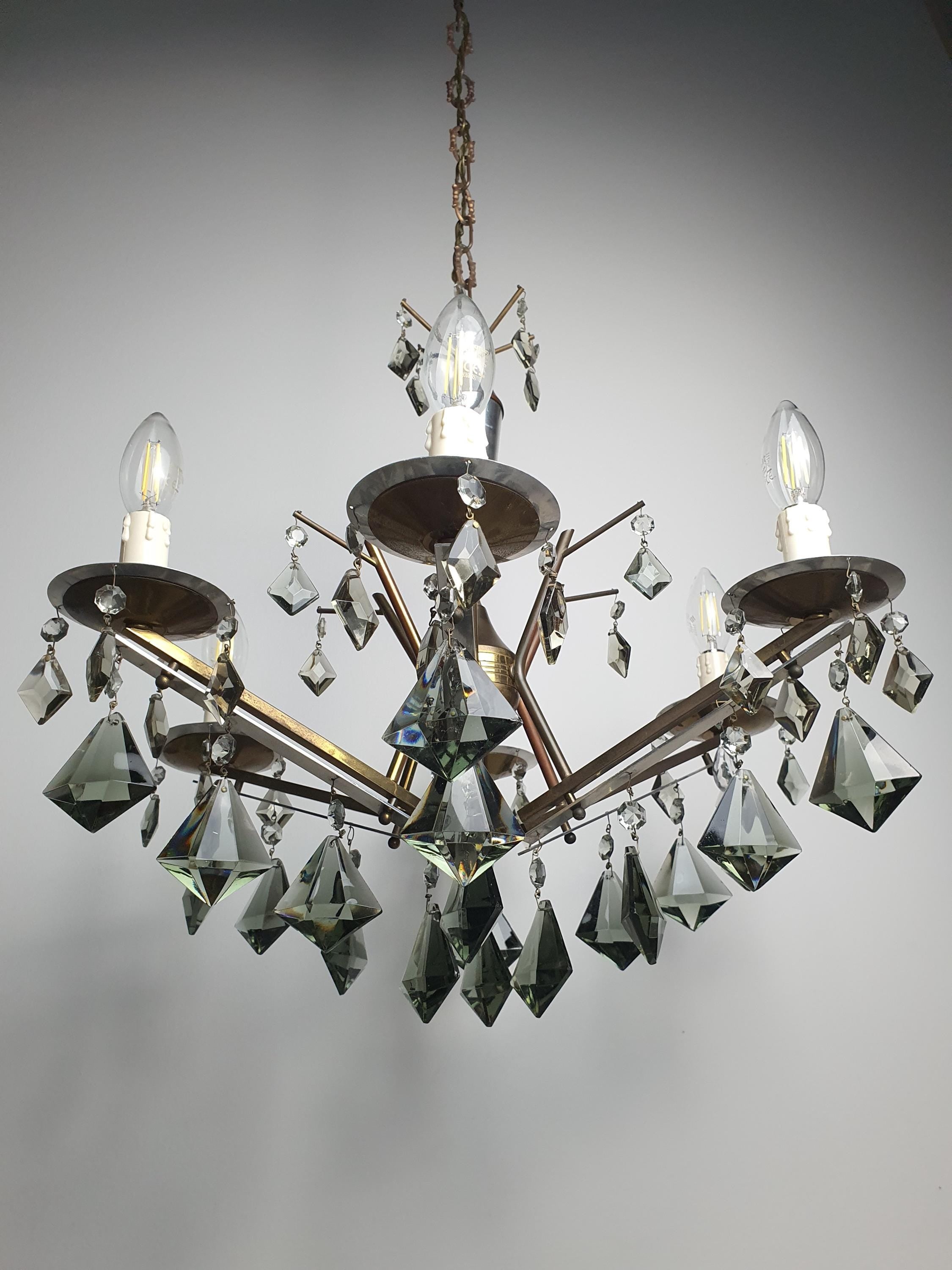 Art Deco 6-arm chandelier front view, smoky grey crystal drops cascading from brass chrome branching frame