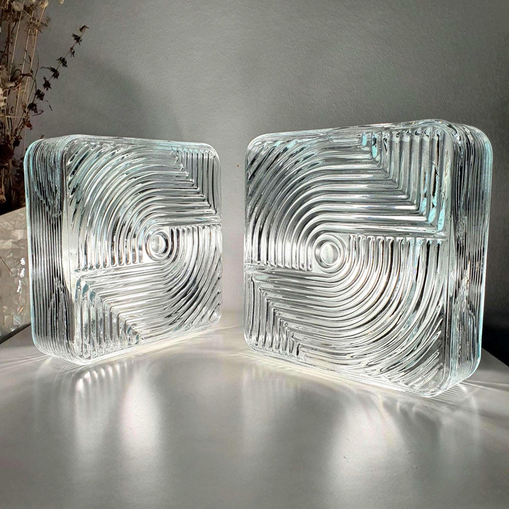 Set of 2 vintage square Brutalist wall sconces — stamped clear glass and black metal, front view