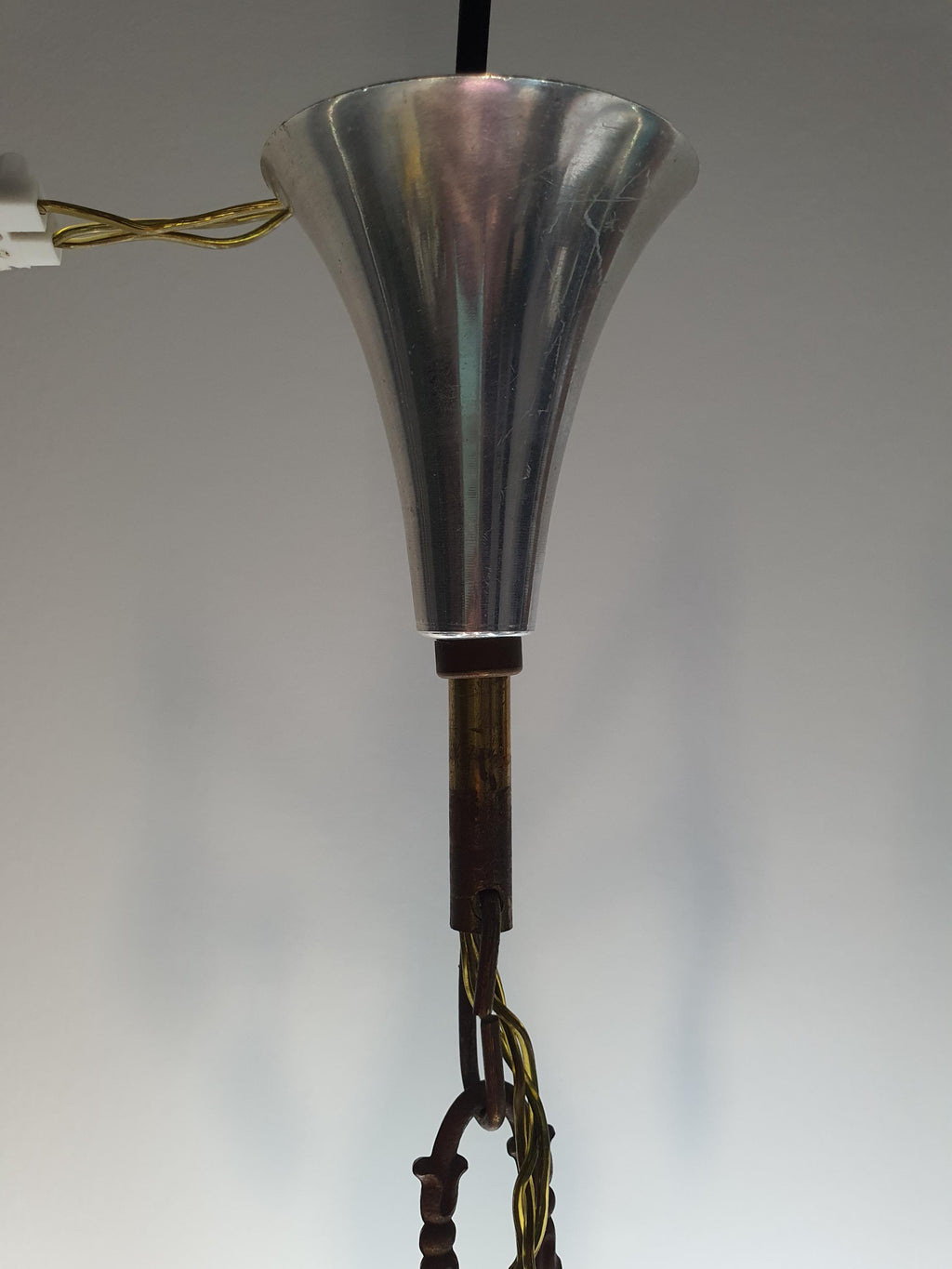 Brass and chrome patina detail on vintage Art Deco 6-arm chandelier frame, smoky grey crystal drops