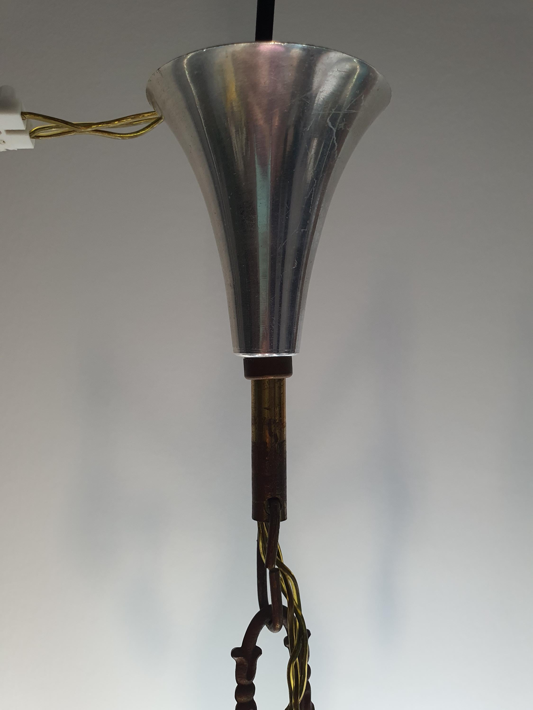 Brass and chrome patina detail on vintage Art Deco 6-arm chandelier frame, smoky grey crystal drops
