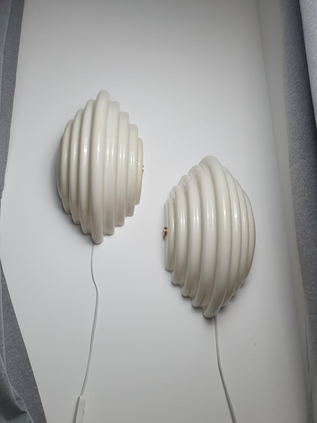 Pair of Sirrah Kumo 2 wall sconces by Kazuhide Takahama — beige acrylic shell form, front view