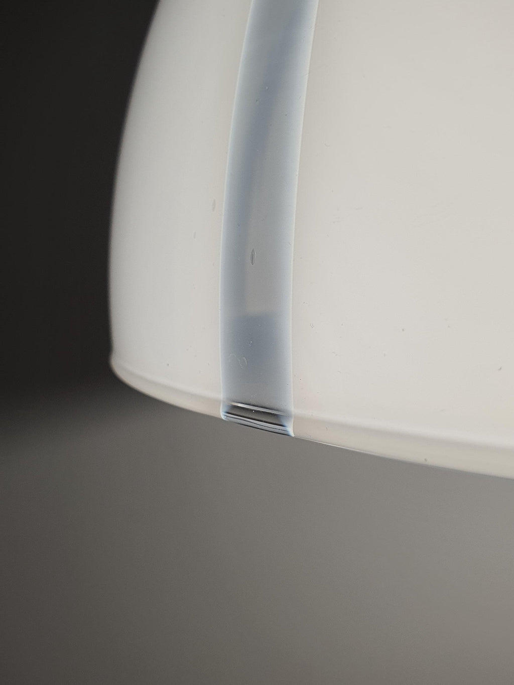 Close-up of white and clear striped glass on vintage Murano bell pendant, transparent and opaque stripe layered effect