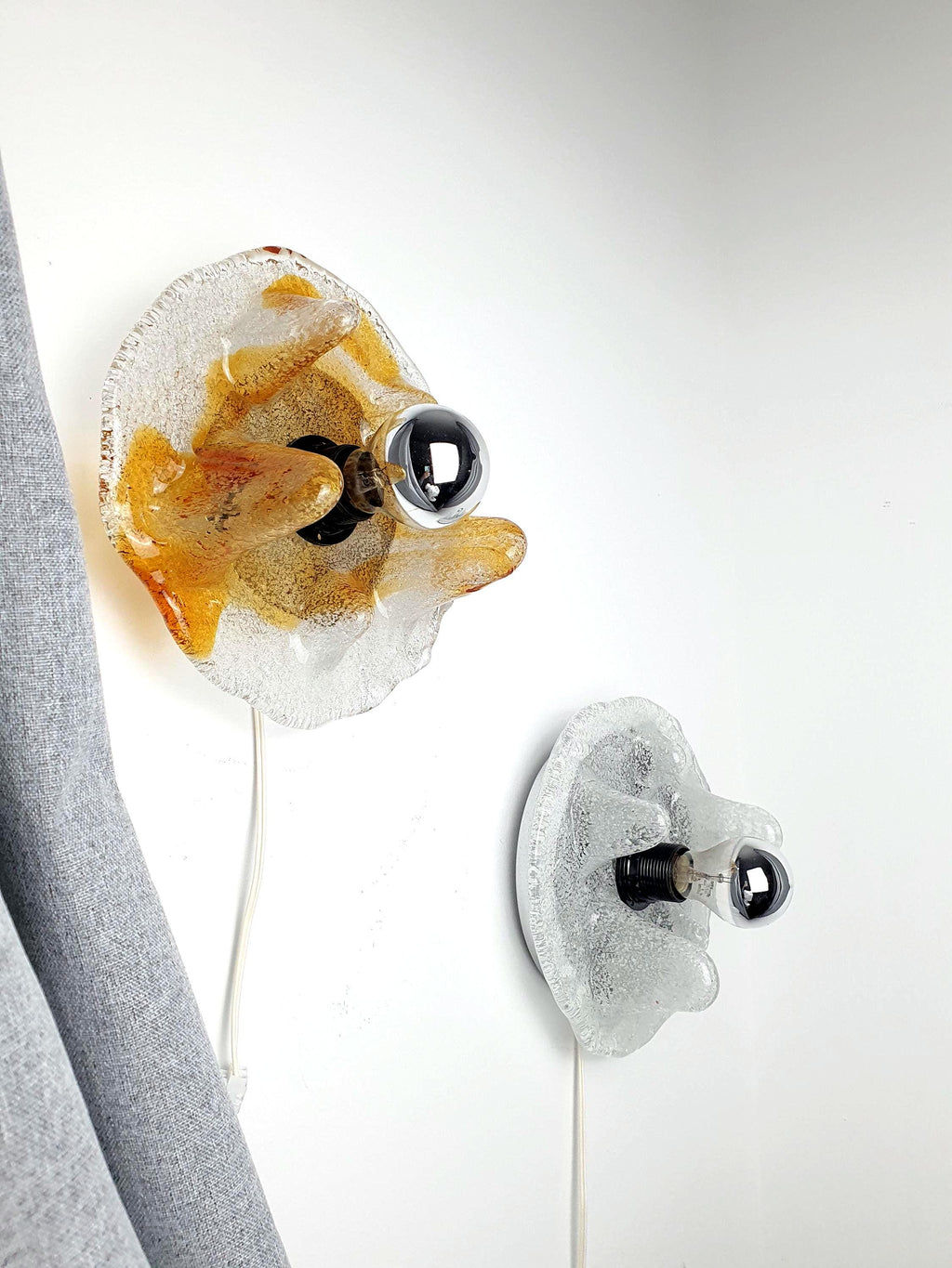 Set of 2 Murano glass wall lights attributed to Toni Zuccheri for Mazzega — caramel and clear drop form, front view
