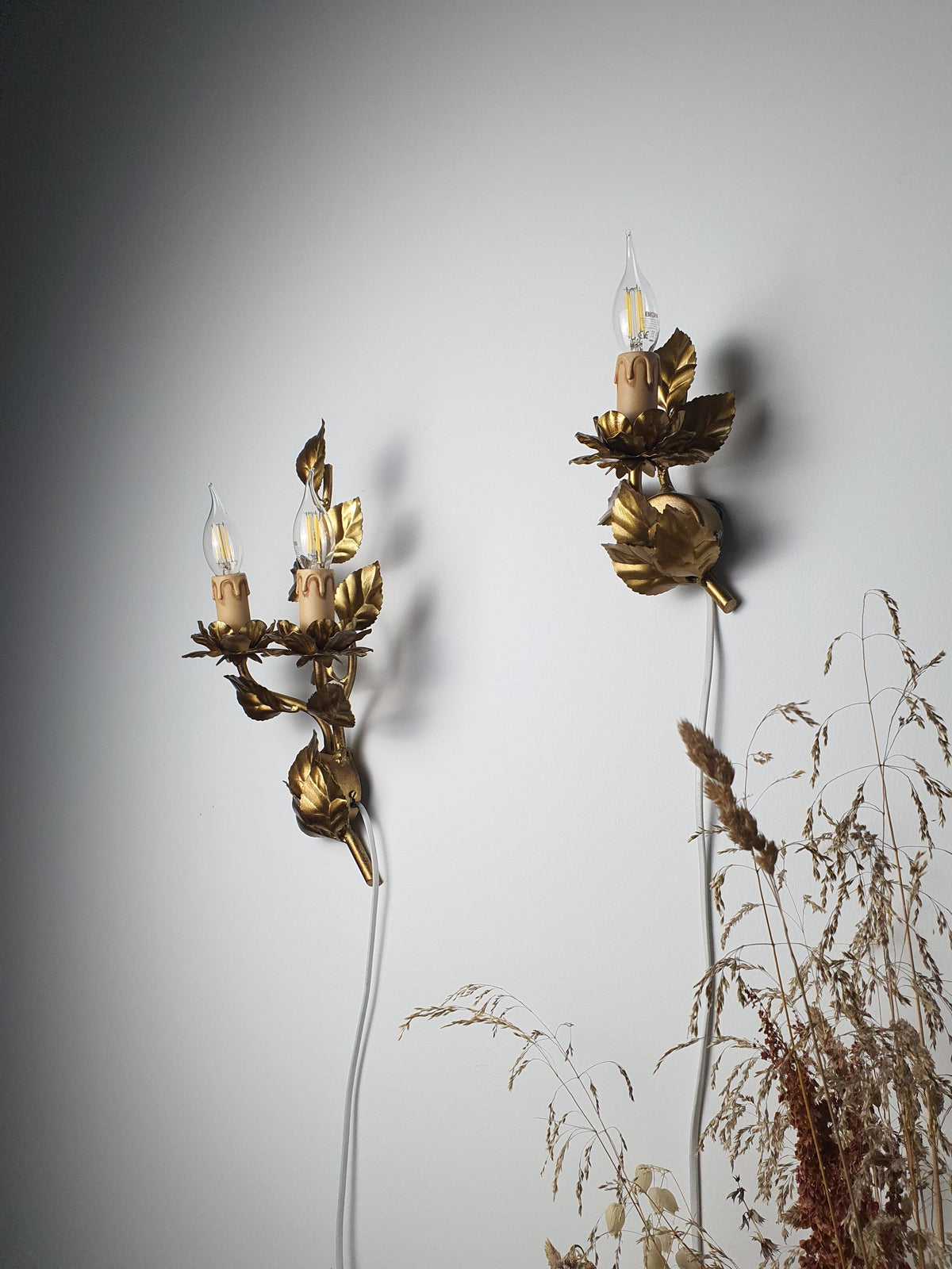 Complementary asymmetrical set of differently sized Italian wall lights
