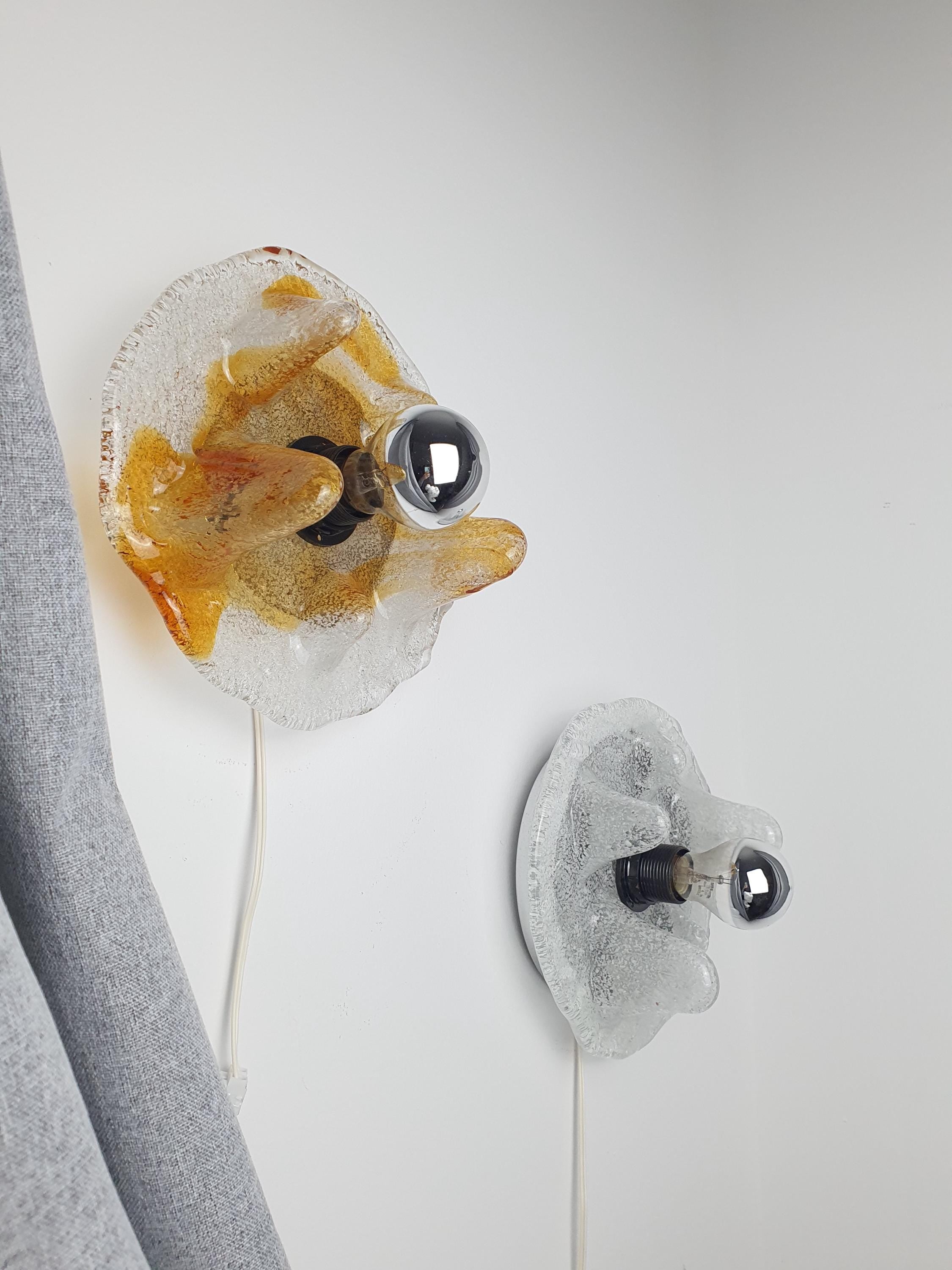 Mazzega Murano glass wall light — illuminated, warm caramel glow through organic drop shade