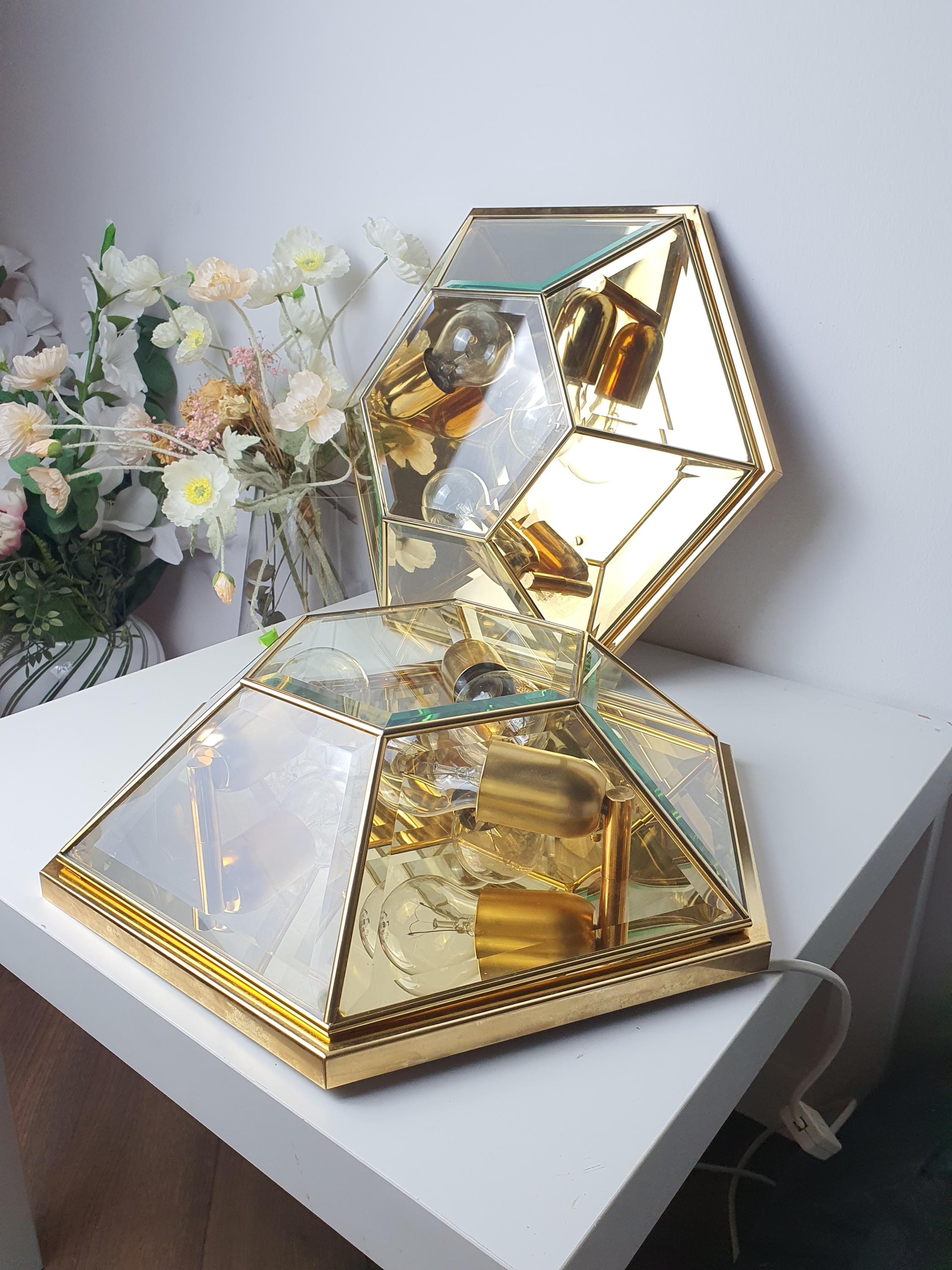 Pair of vintage Italian hexagonal mirror lights lit, bright luminous reflections from mirrored glass panels, Hollywood Regency interior