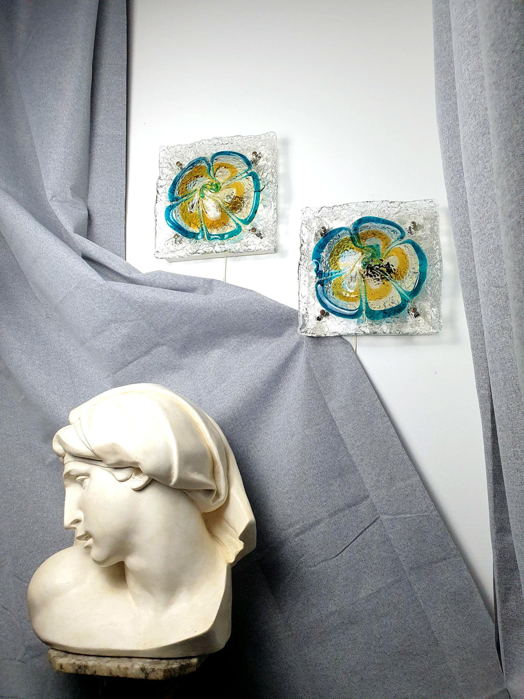 Pair of vintage Mazzega Murano glass floral sconces, turquoise blue caramel amber clear petals, white metal base, Italy 1970s–1980s