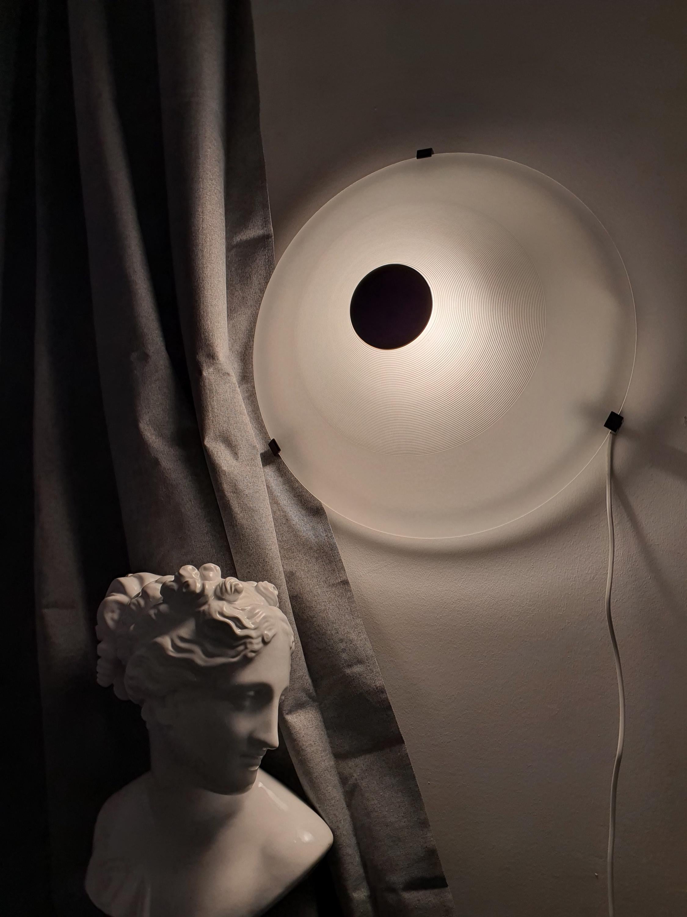 F. Fabbian Memphis pyramid — wall sconce installation, bold graphic design