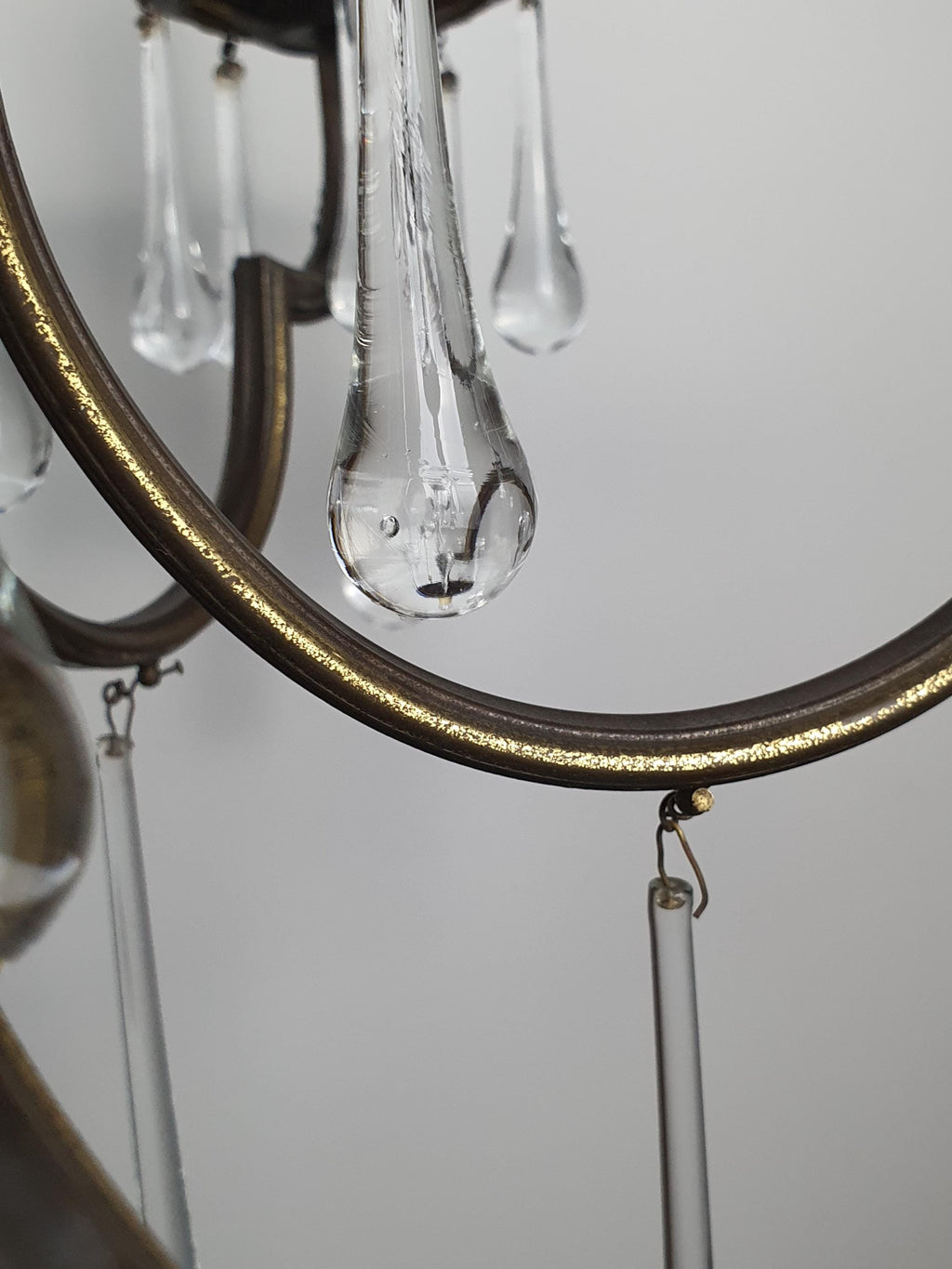 Vintage Italian brass Murano teardrop chandelier in stairwell, cascading clear glass drops, high ceiling installation