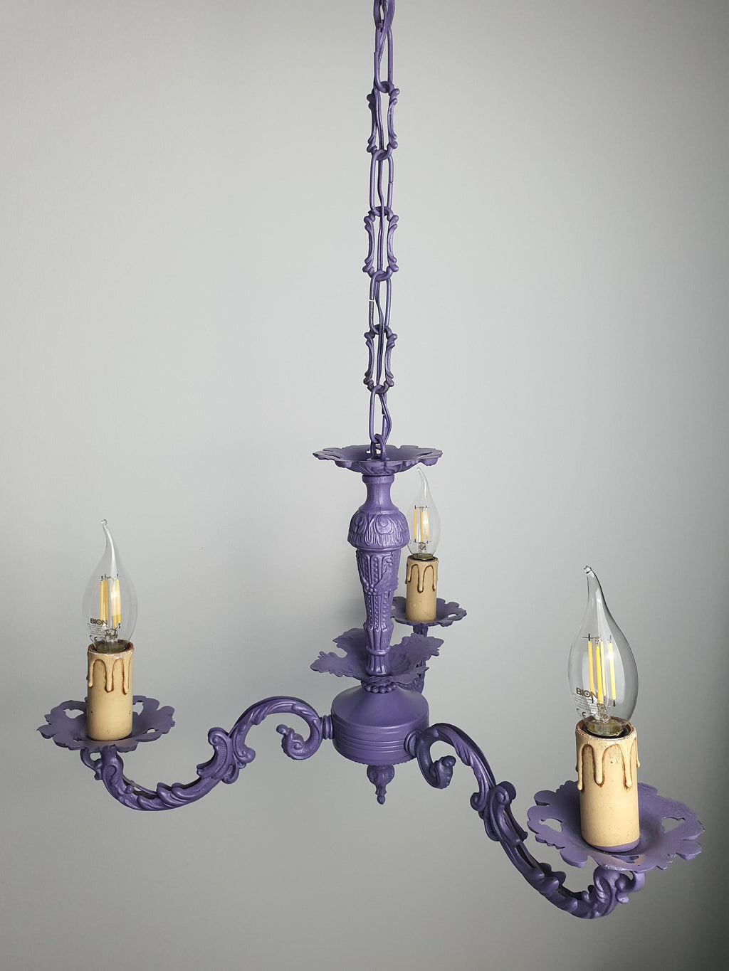 Decorative silhouette of a compact purple candle chandelier
