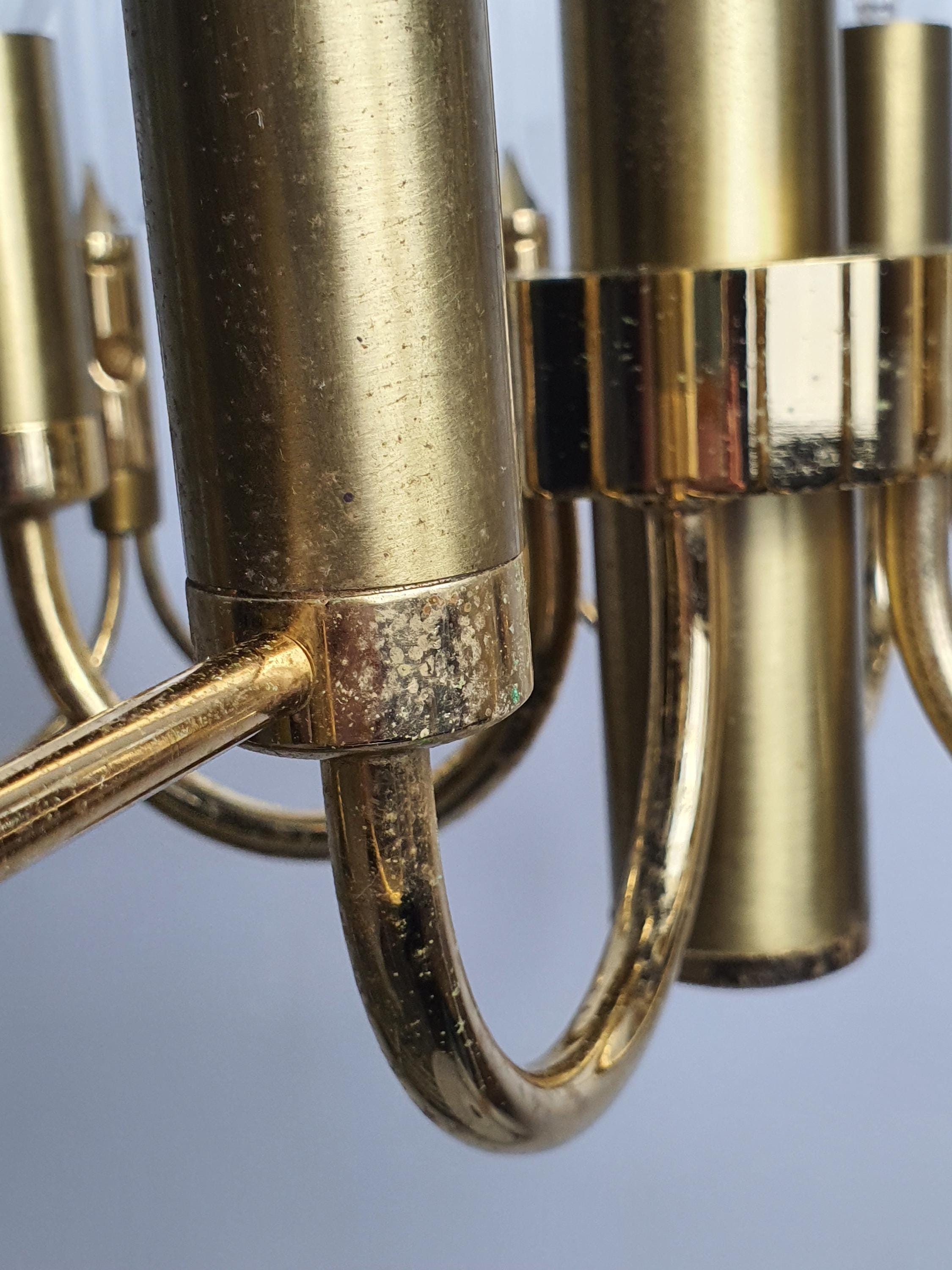 Close-up of faceted crystal drops and double-wave brass motif, vintage Sciolari-attributed 4-arm chandelier